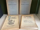 two old books sitting on top of a table next to each other