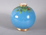 a blue vase with a gold rim on a white background