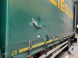 a large green semi truck parked in a parking lot