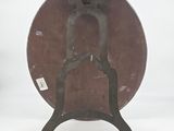 a brown plate with a bird on it on a stand