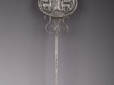 an antique silver spoon with a decorative design on the handle