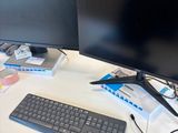 a computer desk with two monitors and a keyboard on it