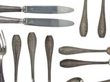 a lot of silver spoons and forks and knives