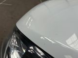 a close up of a car ' s headlight with a sticker on it