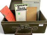 a suitcase filled with books and papers on a white surface