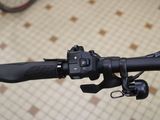 a close up of a bicycle handlebar with a bike in the background