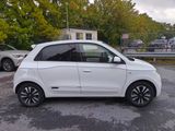 a picture of a small white car parked in a parking lot