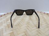a close up of a pair of sunglasses on a woven basket