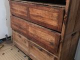 an old wooden chest of drawers in a room with a tiled floor