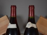 two bottles of wine sitting next to each other on a table