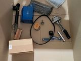 a cardboard box with tools in it and a box on the floor