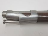 an old gun with a wooden handle on a white surface