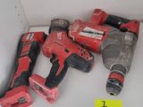 two cordless drillets on a shelf in a room