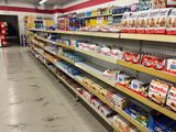 many shelves in a grocery store that are filled with food