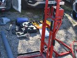 vehicles are parked in a parking lot with tools on the ground