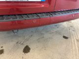 a red car with a sticker on the back of it