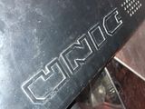 a close up of a black motorcycle with a chrome emblem on it