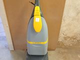 an image of a vacuum cleaner in the corner of a room
