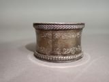a silver ring that is sitting on a table