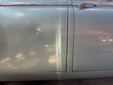 a silver car that is parked on the side of the street
