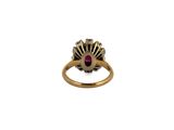 a close up of a gold ring with a ruby stone