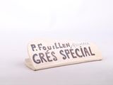 a sign that says frouillen gres special next to a cup of coffee