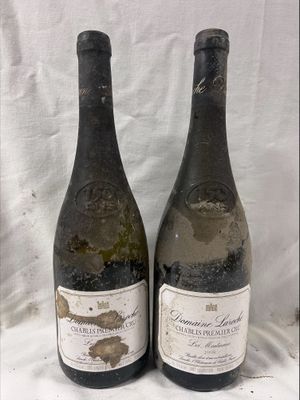 two bottles of wine sitting next to each other on a table