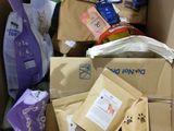 a cardboard box full of cat food and other items