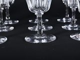 several empty wine glasses are lined up on a black surface