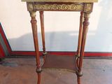 a small wooden table with a mirror on top of it