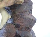 a statue of a woman sitting on a rock