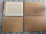 four pieces of brown paper are sitting on top of a wooden floor