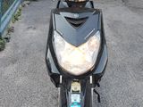 a scooter that is parked in front of a garage