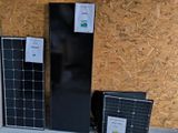 three solar panels sitting on the ground next to each other