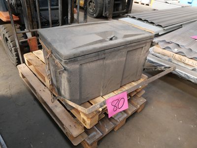 a large gray box sitting on a pallet in a warehouse