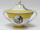 yellow and white soup tureene with a picture of a man on it