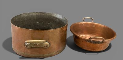 pair of copper pots and pans on a gray surface