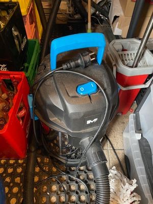 a vacuum that is sitting on the floor next to other items