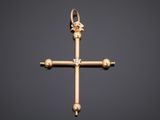 an image of a gold cross with a diamond in the center