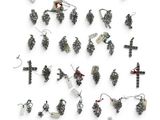 many different types of earrings on display on a white surface