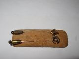 a small piece of wood with a small metal object on it