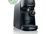 a close up of a black coffee machine with a green label