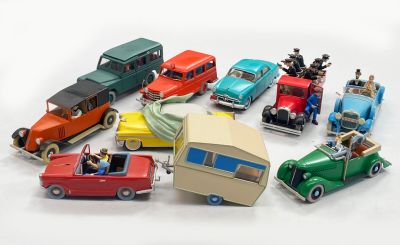 many toy cars that are sitting on a white surface