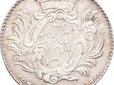 a silver coin with a crown on top of it