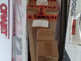 a stack of boxes and a teddy bear sitting on top of it