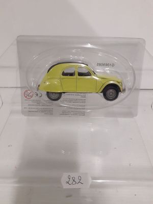 a yellow toy car in a clear plastic box
