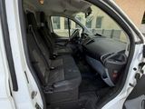 a white van with the door open and the driver ' s seat down