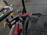 a row of stationary exercise bikes in a gym