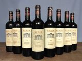 six bottles of wine are lined up in a row on a table