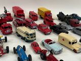 a lot of toy cars and trucks on a white surface